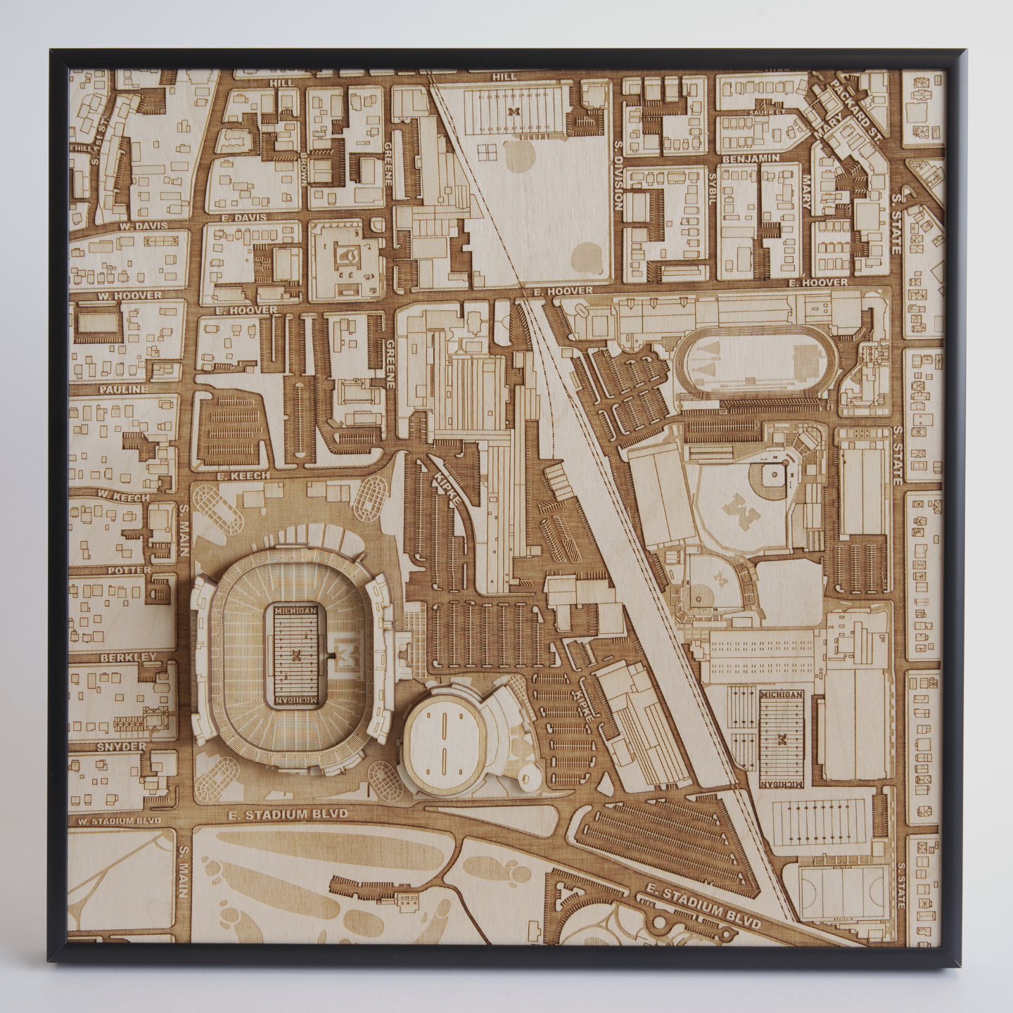 Wooden map model of a city layout with roads and landmarks